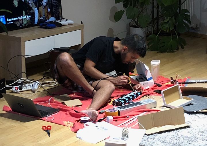 Picture of me soldering a battery on the floor