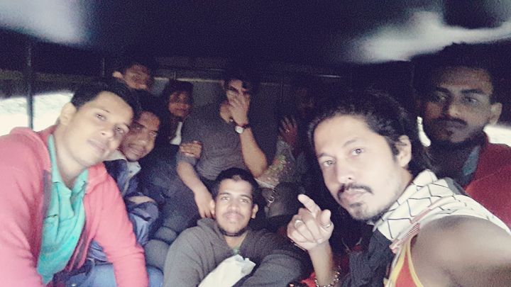 Hitching a ride to worlds end Group of people in back of a pickup truck with roof